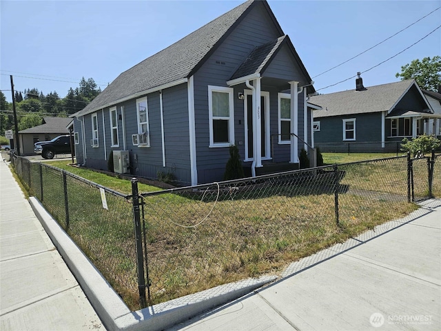 903 W Franklin St, Shelton, WA 98584 - view of front of home with a fenced front yard, a shingled roof, and cooling unit