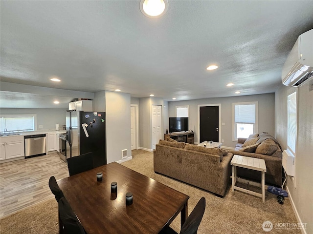 903 W Franklin St, Shelton, WA 98584 - dining space with an AC wall unit, recessed lighting, light colored carpet, and plenty of natural light