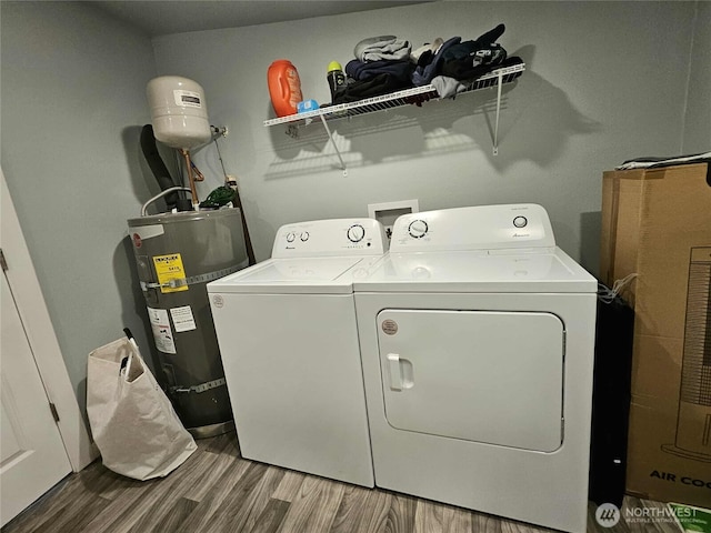 903 W Franklin St, Shelton, WA 98584 - laundry area featuring strapped water heater, washer and clothes dryer, and wood finished floors
