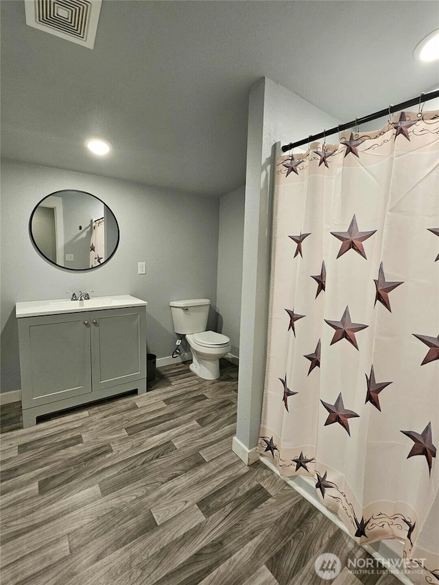903 W Franklin St, Shelton, WA 98584 - full bath with wood finished floors, vanity, curtained shower, and recessed lighting