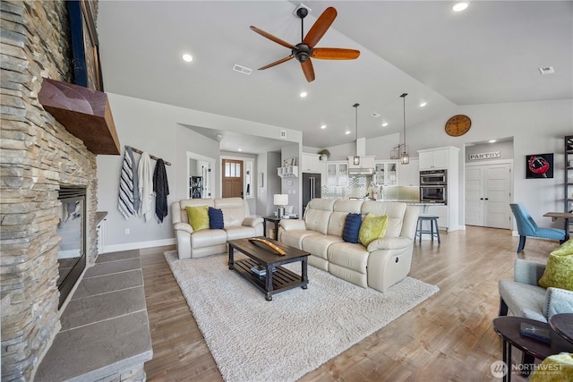 167 N Shore Dr, Orondo, WA 98843 - living room featuring a stone fireplace, ceiling fan, wood finished floors, recessed lighting, and high vaulted ceiling
