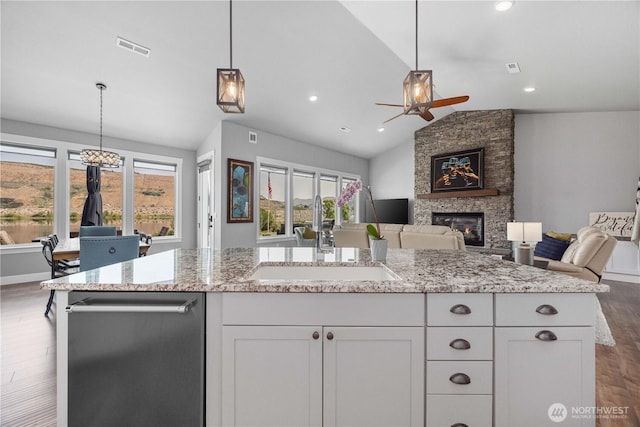 167 N Shore Dr, Orondo, WA 98843 - kitchen with vaulted ceiling, ceiling fan, open floor plan, a stone fireplace, and dark wood-style flooring