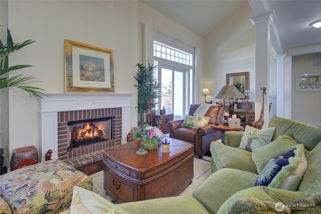 30 Chauncey Ln W, Pacific Beach, WA 98571 - living room with a brick fireplace, ornate columns, lofted ceiling, and wood finished floors