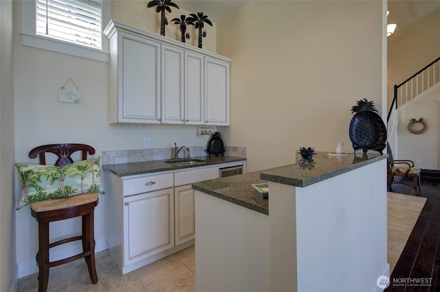30 Chauncey Ln W, Pacific Beach, WA 98571 - kitchen featuring dark stone counters and white cabinets