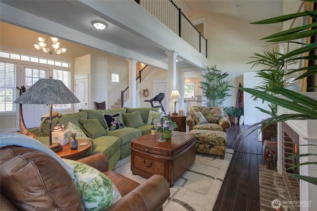 30 Chauncey Ln W, Pacific Beach, WA 98571 - living area with wood-type flooring, decorative columns, stairs, and a chandelier
