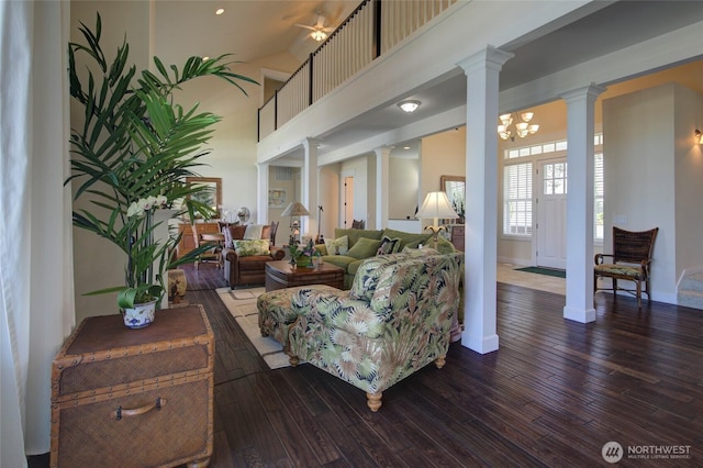 30 Chauncey Ln W, Pacific Beach, WA 98571 - living room featuring ornate columns, wood-type flooring, a chandelier, and a high ceiling