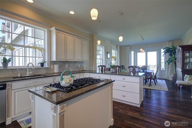 30 Chauncey Ln W, Pacific Beach, WA 98571 - kitchen with black gas cooktop, ornamental molding, a peninsula, dark wood-type flooring, and healthy amount of natural light