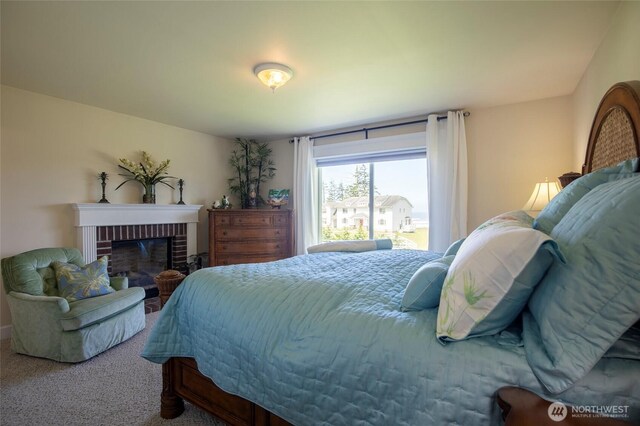 30 Chauncey Ln W, Pacific Beach, WA 98571 - bedroom with carpet floors and a brick fireplace