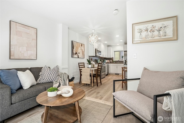 4795 35th Ave S Unit B, Seattle, WA 98118 - living room featuring light wood-style flooring, recessed lighting, and a chandelier
