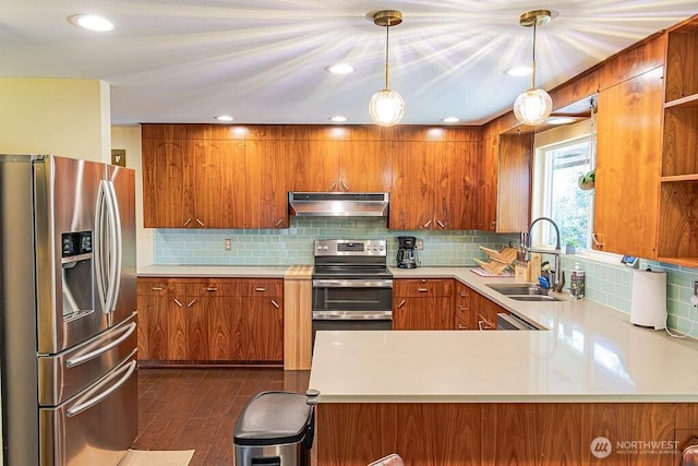 21424 Calhoun Rd, Monroe, WA 98272 - kitchen with appliances with stainless steel finishes, under cabinet range hood, brown cabinetry, light countertops, and recessed lighting