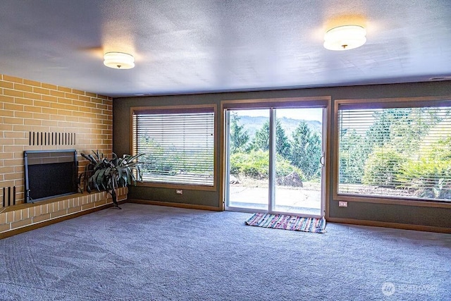 21424 Calhoun Rd, Monroe, WA 98272 - entryway with carpet, a brick fireplace, and a textured ceiling