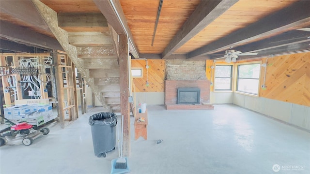 2403 Sunlight Beach Rd, Clinton, WA 98236 - below grade area featuring wooden walls, a ceiling fan, a fireplace, and stairway