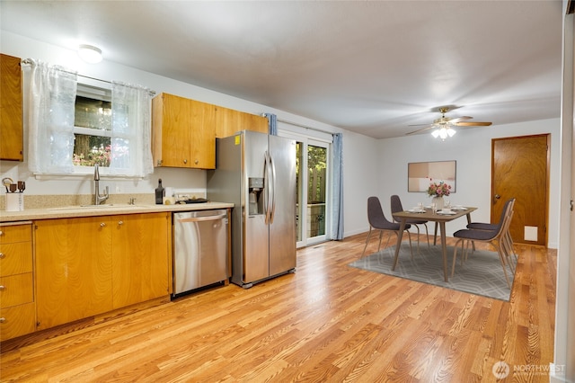 1202 Brookdale Rd E, Tacoma, WA 98445 - kitchen featuring appliances with stainless steel finishes, a sink, light countertops, light wood-type flooring, and ceiling fan