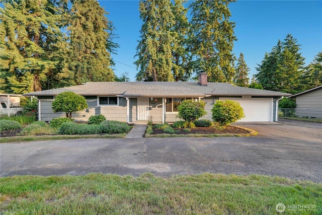 1202 Brookdale Rd E, Tacoma, WA 98445 - single story home with a chimney, a garage, and asphalt driveway