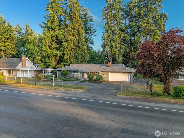 1202 Brookdale Rd E, Tacoma, WA 98445 - view of front of house with driveway, an attached garage, and a chimney