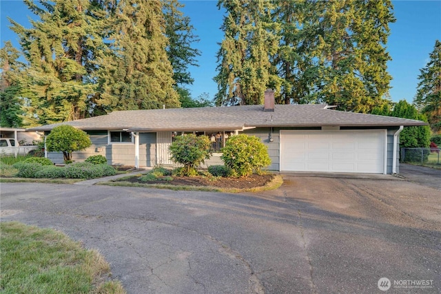 1202 Brookdale Rd E, Tacoma, WA 98445 - ranch-style house featuring asphalt driveway, a chimney, and an attached garage