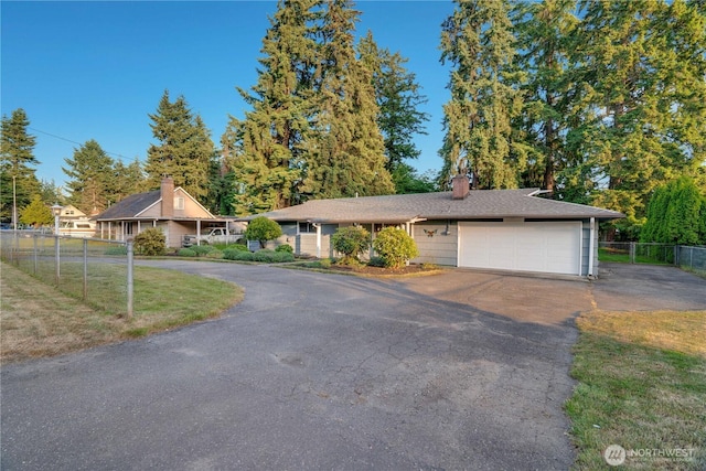 1202 Brookdale Rd E, Tacoma, WA 98445 - view of front of home featuring driveway, a garage, and a chimney