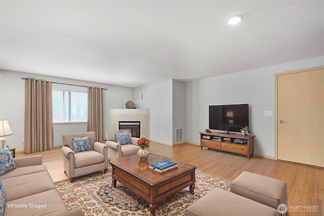 3929 152nd Pl SE, Bothell, WA 98012 - living area featuring light wood-style flooring and a tiled fireplace