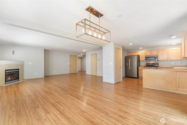 3929 152nd Pl SE, Bothell, WA 98012 - unfurnished living room featuring light wood finished floors, recessed lighting, and a fireplace