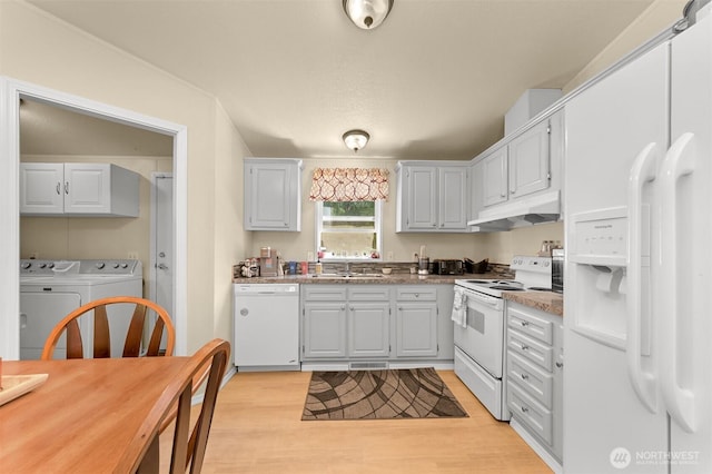 2174 Yew Street Rd Unit 22, Bellingham, WA 98229 - kitchen featuring white appliances, washer and dryer, under cabinet range hood, and light wood finished floors