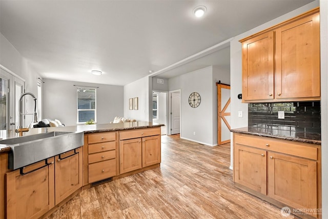 3664 N Red River Rd, Ferndale, WA 98248 - kitchen with backsplash, light wood-style floors, dark stone countertops, and light brown cabinets