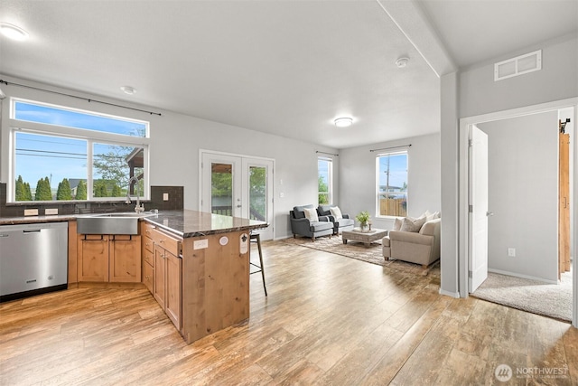 3664 N Red River Rd, Ferndale, WA 98248 - kitchen featuring dishwasher, french doors, open floor plan, a breakfast bar, and a peninsula