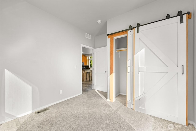 3664 N Red River Rd, Ferndale, WA 98248 - unfurnished bedroom with a barn door and carpet floors