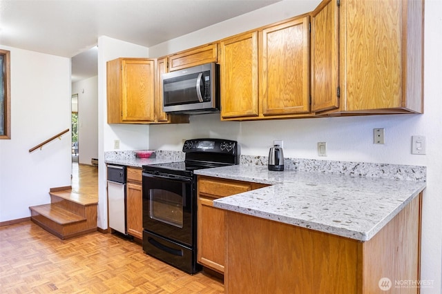 17440 NE 38th St Unit A201, Redmond, WA 98052 - kitchen featuring stainless steel microwave, black range with electric cooktop, light stone countertops, and brown cabinetry