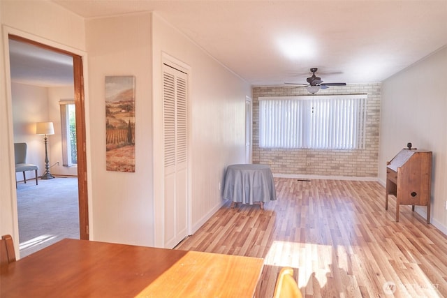4708 63rd Ave W, Tacoma, WA 98466 - unfurnished room with brick wall, a ceiling fan, light wood finished floors, and baseboards