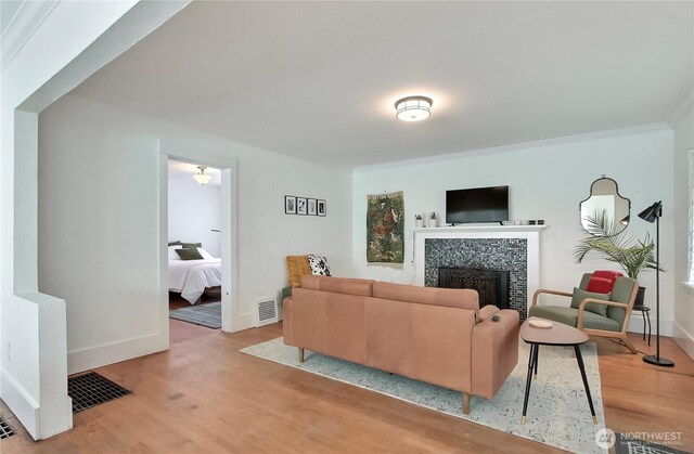 3824 S G St, Tacoma, WA 98418 - living area with a tile fireplace, wood finished floors, and ornamental molding