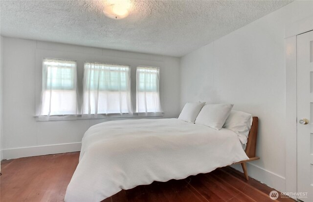 3824 S G St, Tacoma, WA 98418 - bedroom with multiple windows, wood finished floors, and a textured ceiling