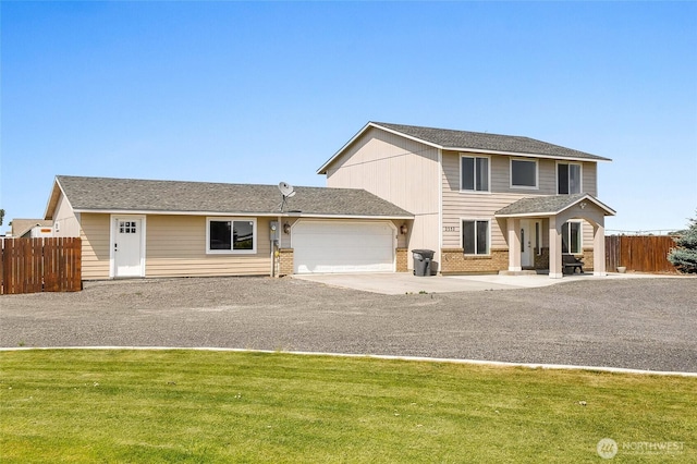 2352 W Covey Dr, Othello, WA 99344 - view of front of property featuring a garage, driveway, and brick siding