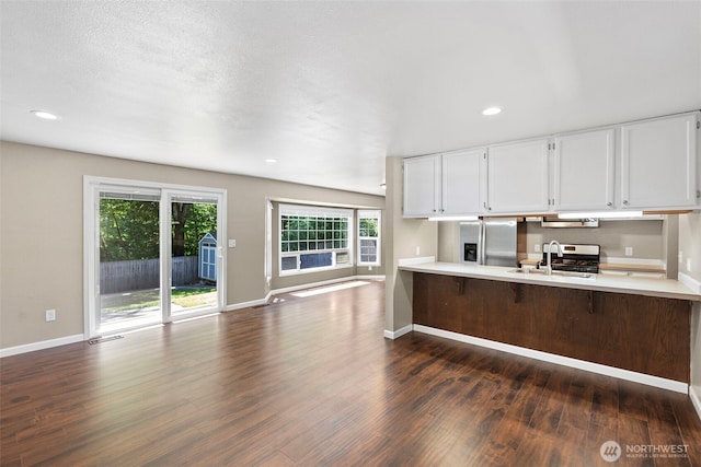 3903 Westpark Ct NW, Olympia, WA 98502 - kitchen featuring stainless steel fridge with ice dispenser, dark wood finished floors, light countertops, white cabinets, and recessed lighting