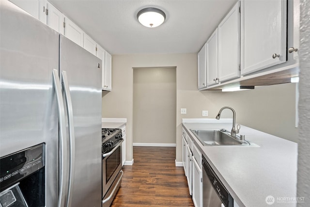 3903 Westpark Ct NW, Olympia, WA 98502 - kitchen with appliances with stainless steel finishes, white cabinets, dark wood-type flooring, and light countertops