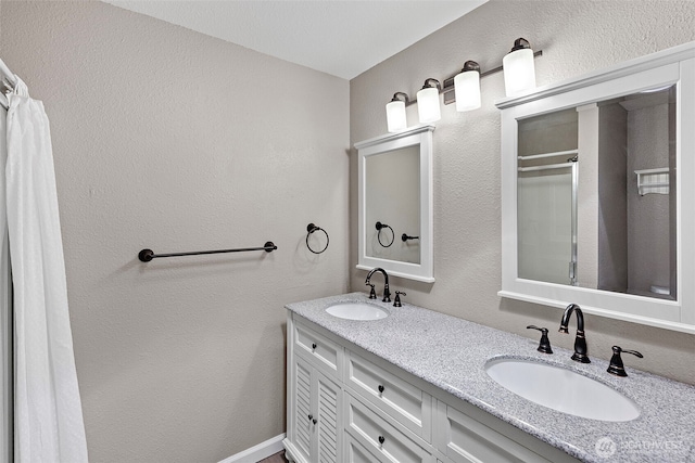 3903 Westpark Ct NW, Olympia, WA 98502 - bathroom featuring double vanity, curtained shower, and a textured wall