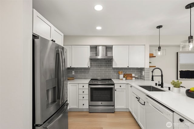 2401 SW Brandon St Unit 210, Seattle, WA 98106 - kitchen featuring appliances with stainless steel finishes, wall chimney range hood, open shelves, light countertops, and tasteful backsplash