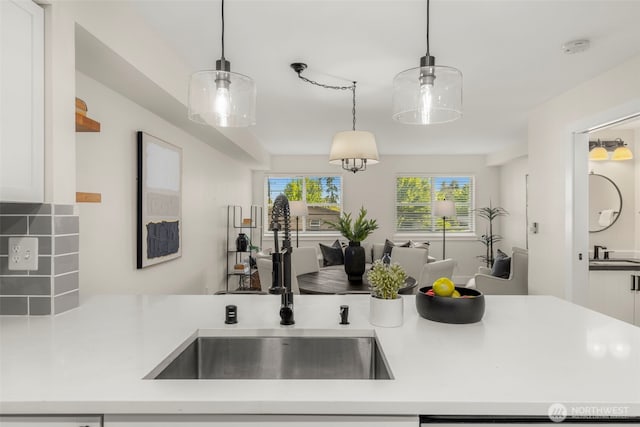2401 SW Brandon St Unit 210, Seattle, WA 98106 - kitchen with light countertops, open floor plan, pendant lighting, and tasteful backsplash