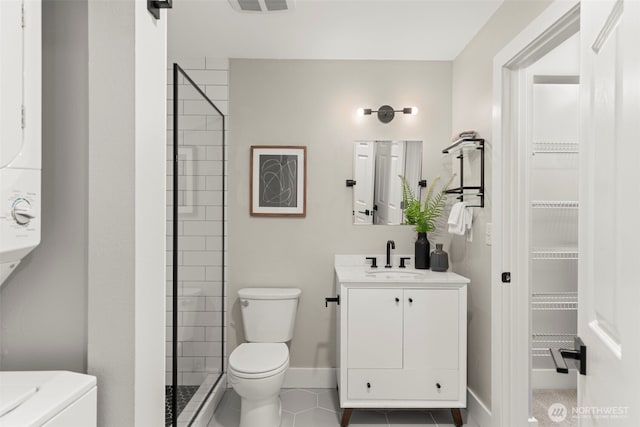 2401 SW Brandon St Unit 210, Seattle, WA 98106 - bathroom featuring tile patterned floors, vanity, a tile shower, and a walk in closet