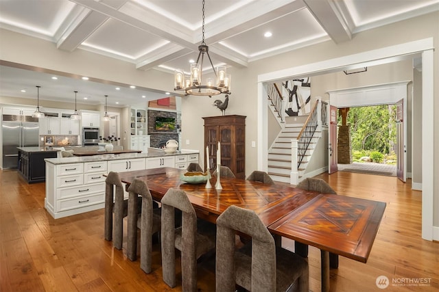 26507 SE Old Black Nugget Rd, Issaquah, WA 98029 - dining space featuring coffered ceiling, light wood-style floors, stairs, a chandelier, and beam ceiling