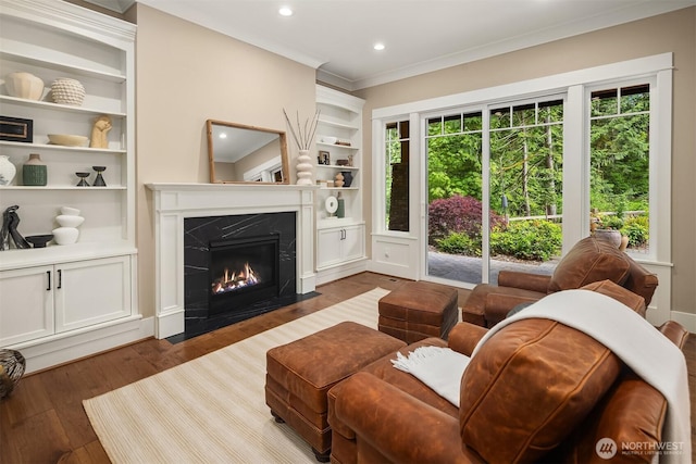 26507 SE Old Black Nugget Rd, Issaquah, WA 98029 - living area with built in features, wood finished floors, a high end fireplace, ornamental molding, and recessed lighting