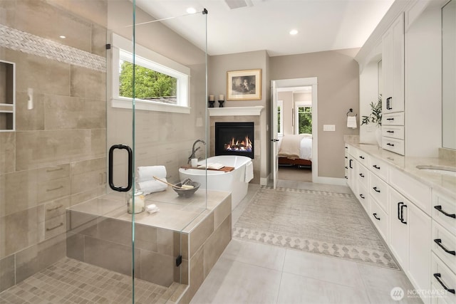 26507 SE Old Black Nugget Rd, Issaquah, WA 98029 - ensuite bathroom featuring healthy amount of natural light, tile patterned floors, vanity, a soaking tub, and recessed lighting