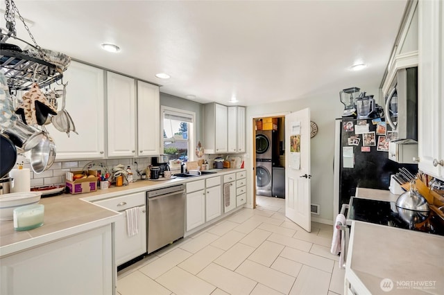 10825 4th Ave W, Everett, WA 98204 - kitchen with stacked washer / drying machine, stainless steel appliances, white cabinetry, light countertops, and recessed lighting