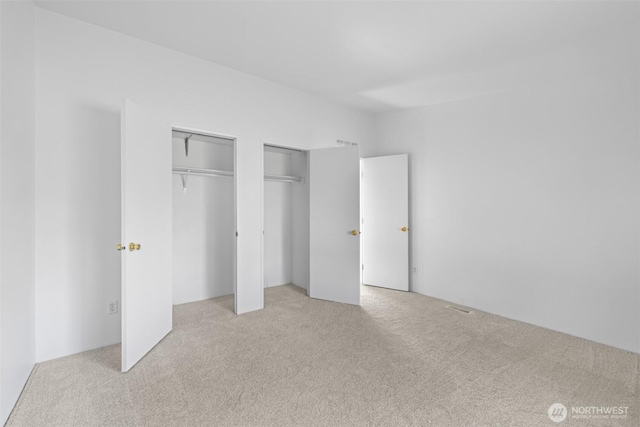 140 Big Sky Ln, Sequim, WA 98382 - unfurnished bedroom with multiple closets and carpet flooring