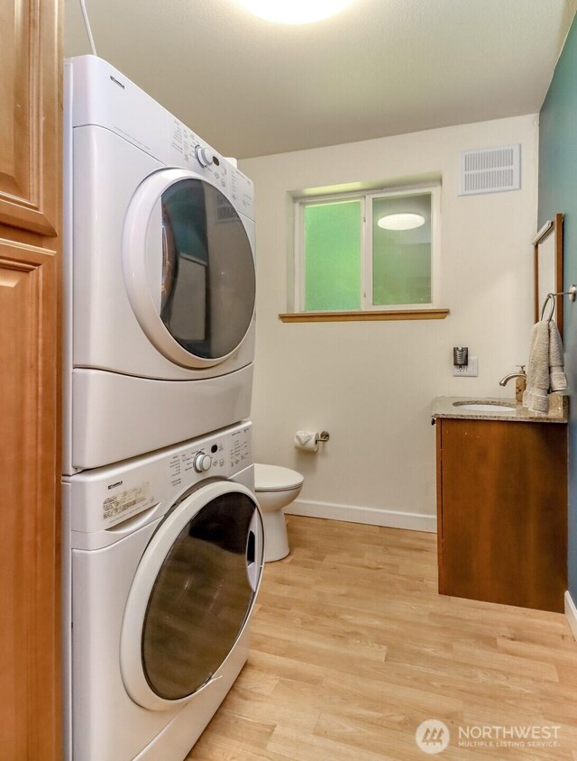 23310 133rd Ct SE, Kent, WA 98042 - laundry room with stacked washer and clothes dryer and light wood-style floors