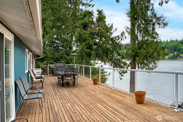 18933 W Big Lake Blvd, Mount Vernon, WA 98274 - wooden deck featuring a water view, outdoor dining space, grilling area, and view of scattered trees