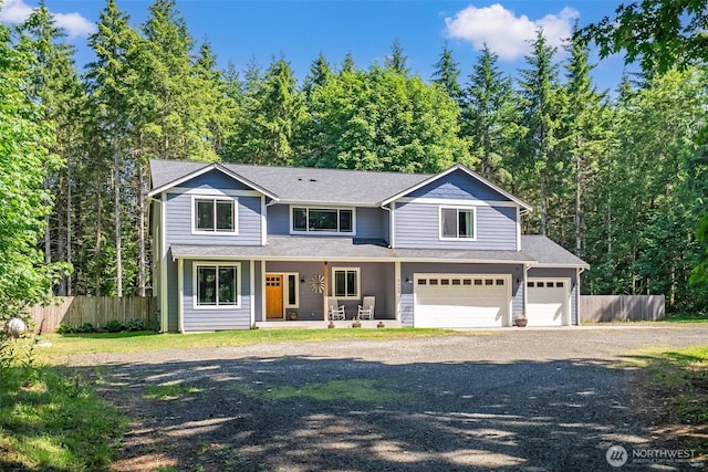 5609 Stetson Ct NW, Olympia, WA 98502 - traditional-style house featuring covered porch, driveway, a garage, a forest view, and roof with shingles