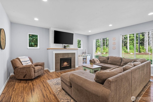 5609 Stetson Ct NW, Olympia, WA 98502 - living area featuring healthy amount of natural light, a tiled fireplace, recessed lighting, and wood finished floors