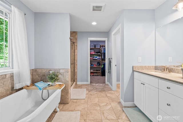 5609 Stetson Ct NW, Olympia, WA 98502 - bathroom featuring a stall shower, vanity, a soaking tub, a spacious closet, and recessed lighting