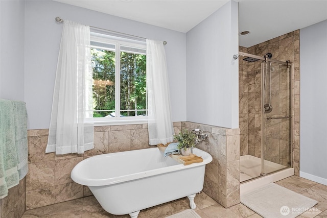 5609 Stetson Ct NW, Olympia, WA 98502 - bathroom featuring a freestanding tub, a stall shower, plenty of natural light, tile walls, and wainscoting