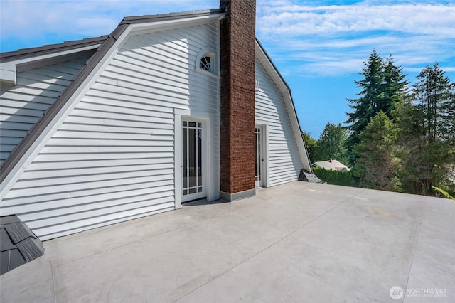4918 S 3rd Ave, Everett, WA 98203 - view of side of property with a patio, a chimney, and a gambrel roof